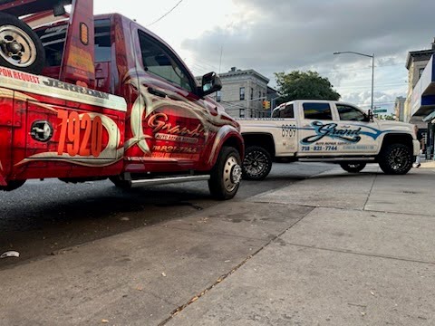 2 Tow Trucks with the Grand Auto logo on them